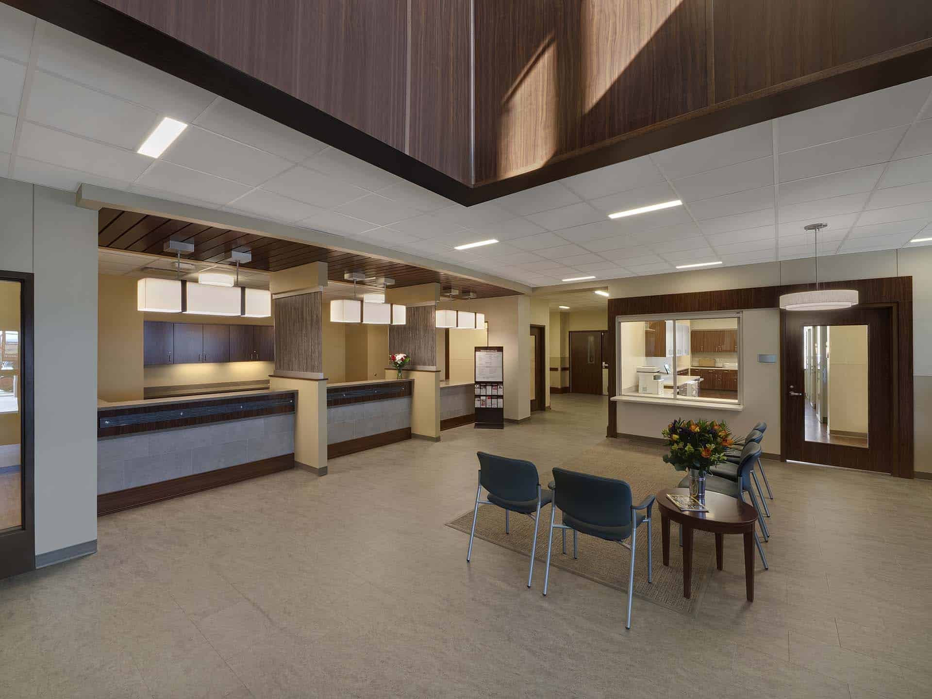 Waiting room with multiple chairs and check in desks