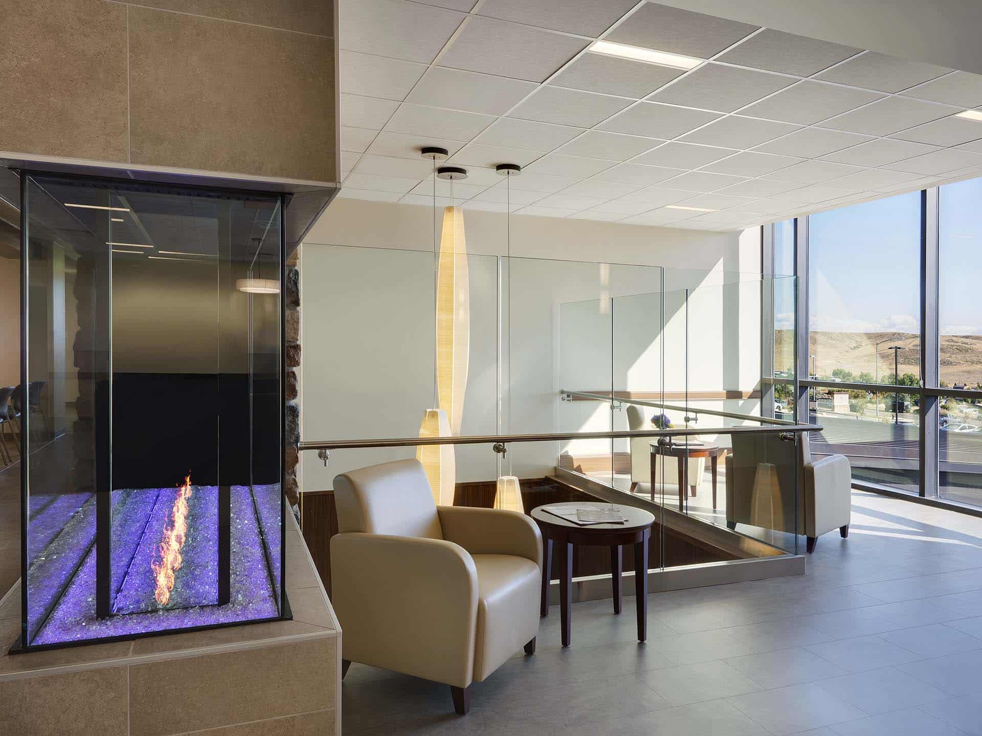 Waiting room with decorative glass fireplace and chairs