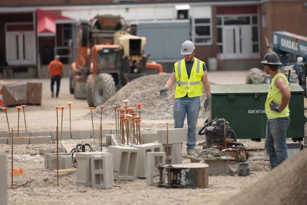 Workers preparing materials at a construction site.