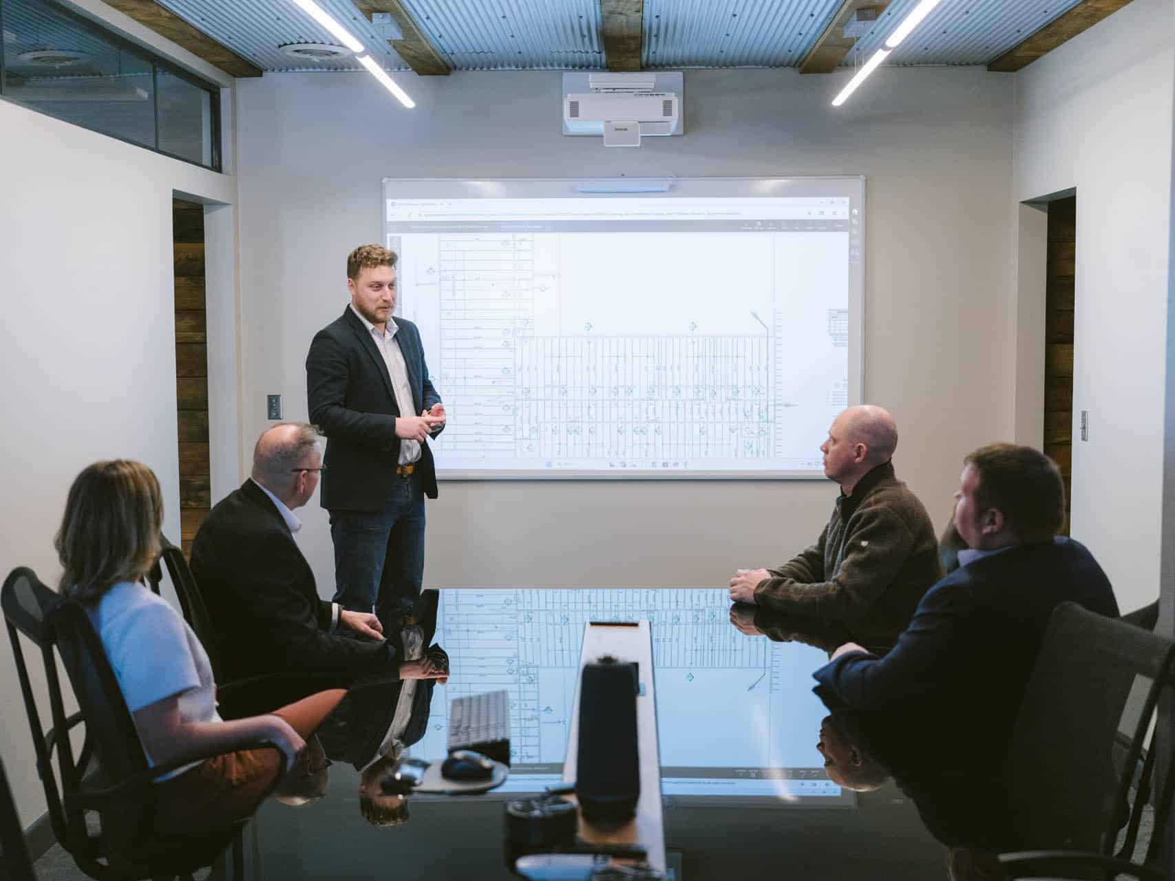 Adena leaders reviewing designs in conference room.